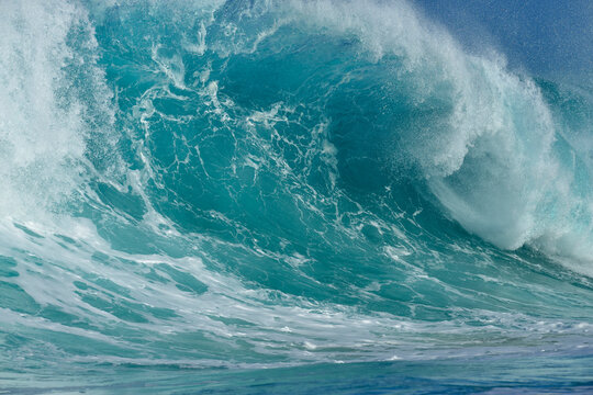 Powerful breaking ocean wave with spray in Oahu Hawaii