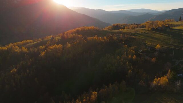 Awe-inspiring Panoramic Aerial Pull Back Over Golden Autumn Hills Towards the Sunset in Poiana Marului Cinematic 4K Graded