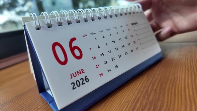 Slow motion footage of flip calendar pages for change months from may to june of the year 2026. concept of planning and starting a new month. 4k horizontal.