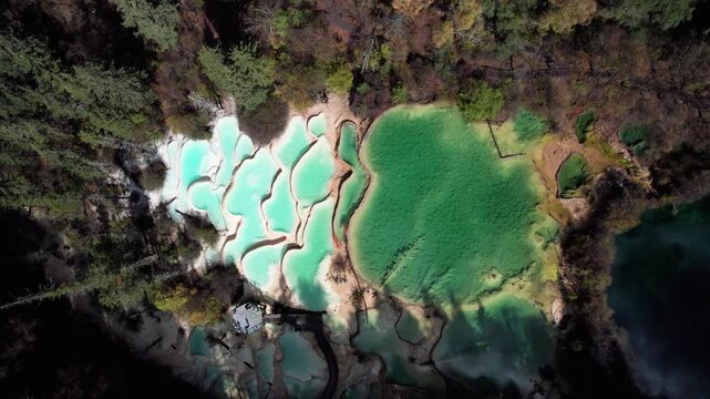 Drone view of Shenxianchi Scenic Area in Sichuan, China, near Jiuzhaigou and Huanglong, peaceful and clean water in pond among mountains, 4k real time footage travel concept.