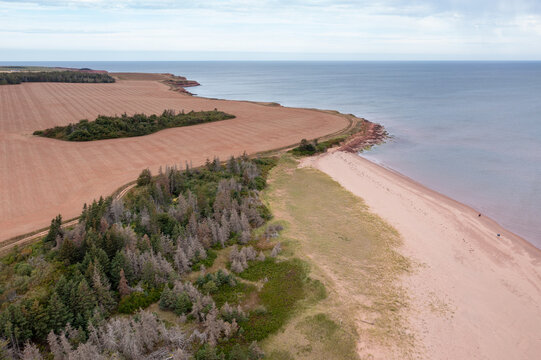 Aerial drone photo of the beautiful beach in Summerside, Prince Edward Island in Canada showing the beach front and secluded golden sandy beaches on a sunny day in the autumn time