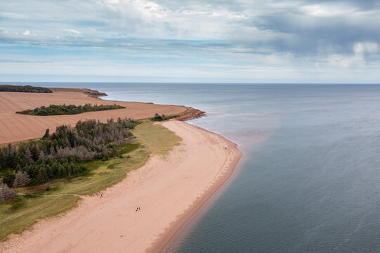 Aerial drone photo of the beautiful beach in Summerside, Prince Edward Island in Canada showing the beach front and secluded golden sandy beaches on a sunny day in the autumn time