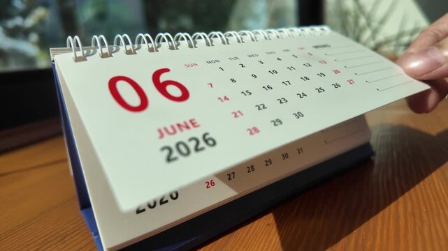 Slow motion footage of flip calendar pages for change months from june to july of the year 2026. concept of planning and starting a new month. 4k horizontal.