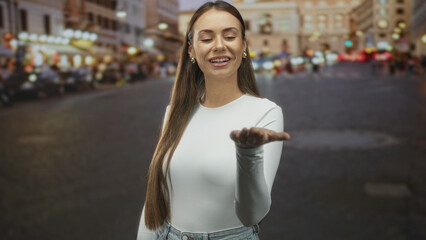 Woman displays open palm gesture on street while looking at her hand and wearing gold hoop earring  curiosity discovery. © Krakenimages.com