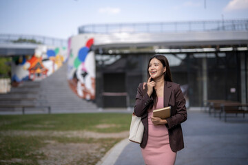 Fototapeta premium Young asian businesswoman contemplating new ideas outdoors