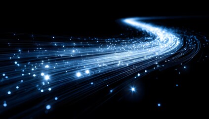Abstract flowing blue light streaks with glowing particles, representing fiber optics data transfer, speed, technology, and connectivity, dark background