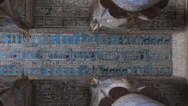 Ancient Egyptian Dendera Temple. Ornate hieroglyphic ceiling and massive stone columns with original blue pigment preserved. Perfect for history documentaries.. Downscaled from 6k.