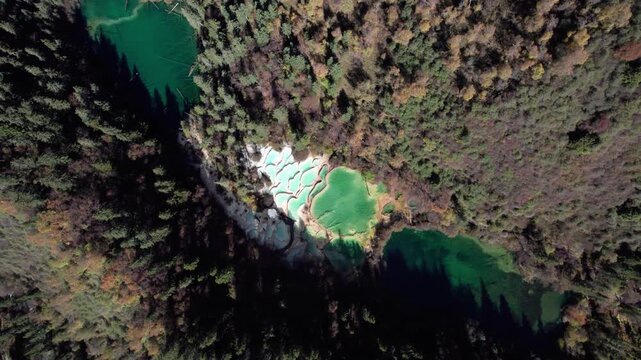 Drone view of Shenxianchi Scenic Area in Sichuan, China, near Jiuzhaigou and Huanglong, peaceful and clean water in pond among mountains, 4k real time footage travel concept.