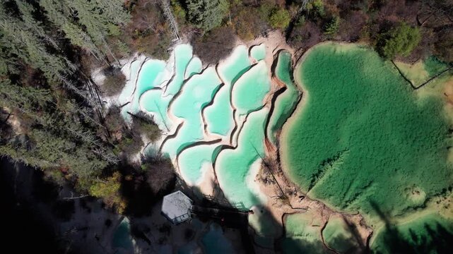 Drone view of Shenxianchi Scenic Area in Sichuan, China, near Jiuzhaigou and Huanglong, peaceful and clean water in pond among mountains, 4k real time footage travel concept.