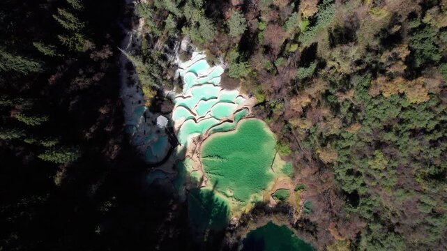Drone view of Shenxianchi Scenic Area in Sichuan, China, near Jiuzhaigou and Huanglong, peaceful and clean water in pond among mountains, 4k real time footage travel concept.