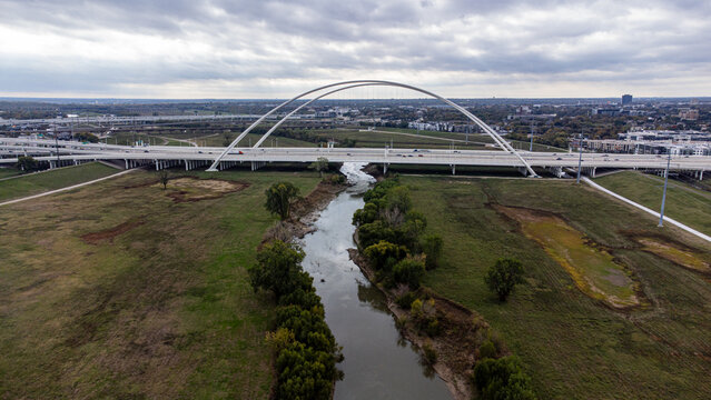 Aerial view of the Margaret Hunt Hill Bridge soaring over the Trinity River, a modern marvel against the Texas sky, Dallas, Texas, United States.