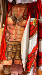 Roman soldier themed souvenir apron displayed in tourist shop representing Roman gladiator costume humor souvenir in Rome, Italy.