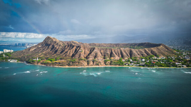Aerial view of the Diamond Head volcano crater, a dormant volcanic tuff cone, rises majestically from the turquoise waters, Honolulu, Hawaii, United States.