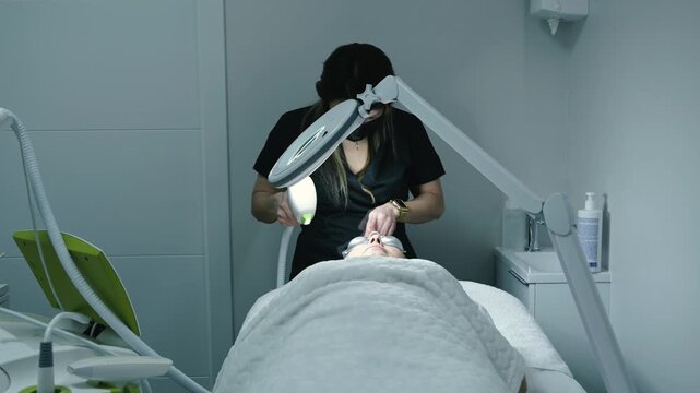 Esthetician performing laser skin resurfacing facial treatment