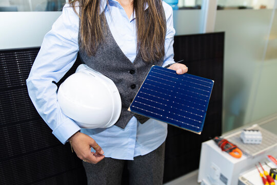 Manager presenting solar panel sample in office workplace