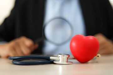 Naklejka premium The doctor's hand is choosing the heart for medical health care for safety insurance for sick illness wellbeing protection plan or retirement healthy therapy treatment or health checkup concepts.