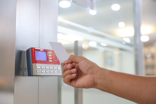 Hand scanning proximity ID card on reader access control system to security door unlock with identity or verification identify icons for safety detect fingerprint scan or check attendance.