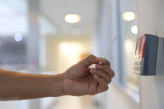 Hand scanning proximity ID card on reader access control system to security door unlock with identity or verification identify icons for safety detect fingerprint scan or check attendance.