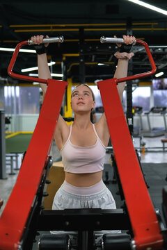 Athlete performing strength training on gym machine during workout