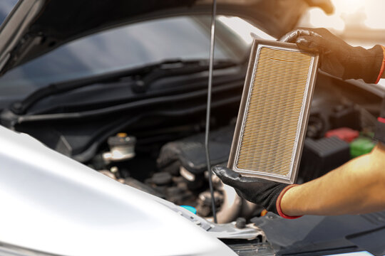 Auto mechanic holding car air conditioner filter for check and clean dirty or fix repair heat have engine problem or replace new change air filter of car care maintenance servicing concepts.