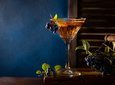 Refreshing blueberry cocktail in martini glass with garnish
