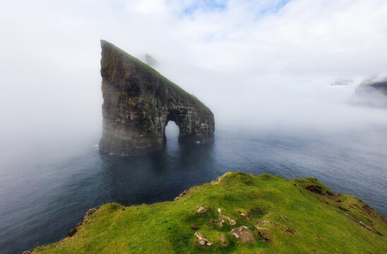 Faroe Islands - The beautiful Drangarnir Arch on the Atlantic ocean landscape with cliff