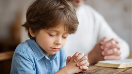Fototapeta premium Young child learning to pray in church, small hands mimicking folded hands, parent over sacred text guidance, youth prayer instruction, faceless teaching moment, defocused background, with copy