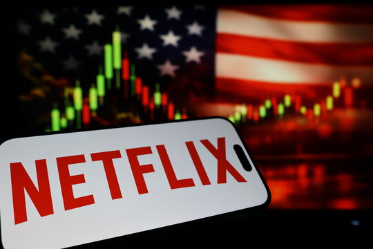 Kiel, Germany - 03-03-2026: US streaming company Netflix Inc. logo on smartphone against US flag and rising stock market candlestick chart concept