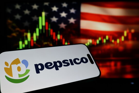 Kiel, Germany - 03-03-2026: US beverage and snack company PepsiCo Inc. logo on smartphone against US flag and rising stock market candlestick chart concept