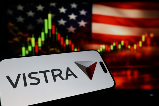 Kiel, Germany - 03-03-2026: US power generation company Vistra Corp. logo on smartphone against US flag and rising stock market candlestick chart concept