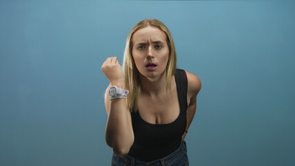 Woman with palms up shrugging gesture, hands raised showing watch and bracelets toward camera in...