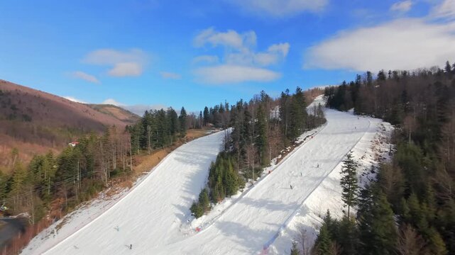 Unforgettable FPV drone footage: skiers and snowboarders in Szczyrk, Solisko, surrounded by winter scenery.