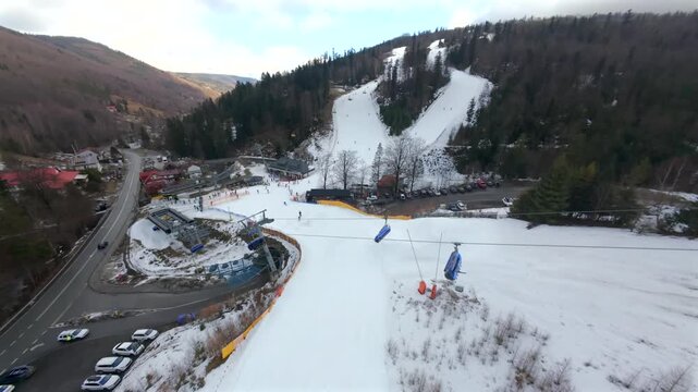 Unique FPV perspective on the winter slopes of Solisko. Skiers and snowboarders in a snowy landscape.