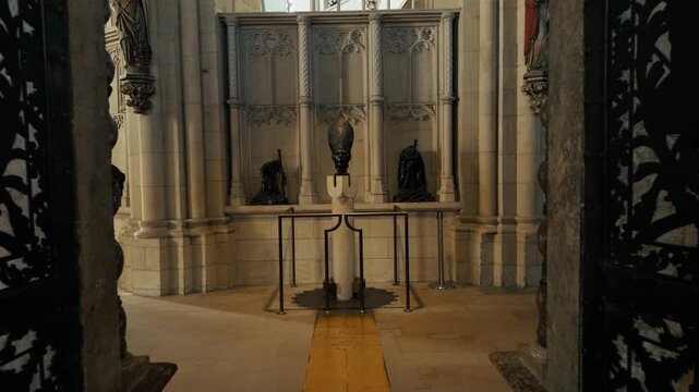 Interior view inside St Paulus Dom Cathedral in M&uuml;nster, Germany featuring historic sculpture display framed by stone arches. Gothic church architecture with religious artwork and quiet atmosphere.