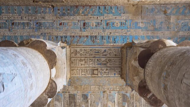 Dendera temple or Temple of Hathor. Painted columns with goddess faces and hieroglyphic ceiling of the hypostyle hall. Downscaled from 6k.