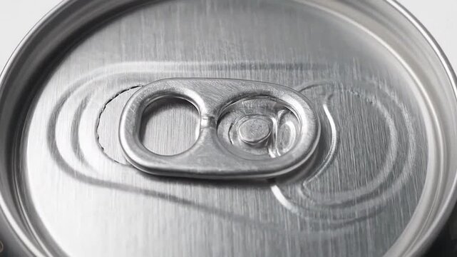 Close-up view of multiple metallic beverage containers with pull tabs