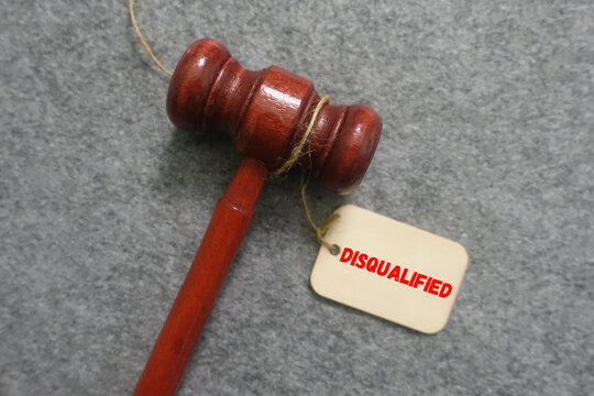 Red wooden gavel with disqualified tag