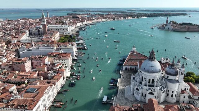 Drone shot over St. Mark's Basin with bustling boat traffic in Venice, Italy