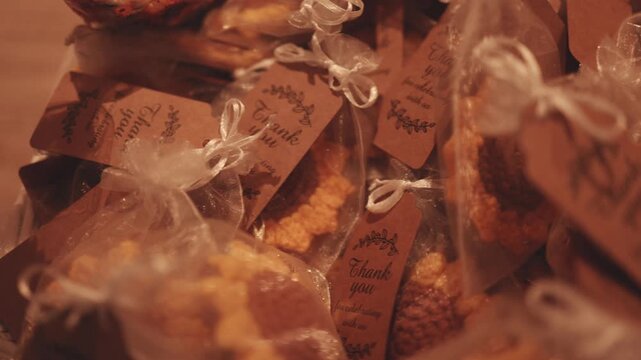 Gift packages for guests. They have a note that says, &ldquo;Thank you for celebrating with us.&rdquo; The video captures a lot of presents.