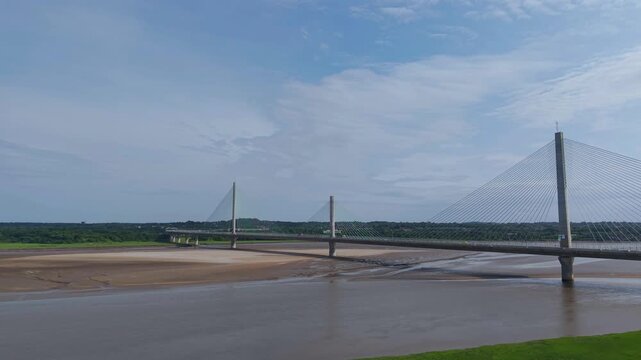 Liverpool, Merseyside, UK, June 19, 2025; Aerial 4K video footage of the Mersey Gateway toll bridge with stunning views over the River Mersey, Liverpool, UK.