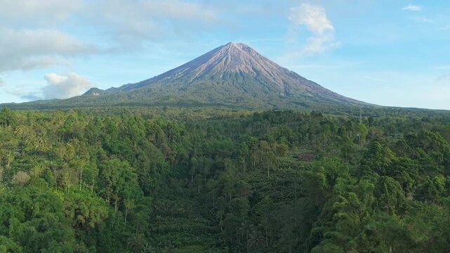 Aerial view of the majestic semeru volcano, an active stratovolcano in east java, indonesia, surrounded by a dense tropical forest