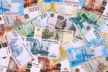 Fototapeta premium Russian ruble money bills pile on table. Russia banknotes of RUB currency close up.