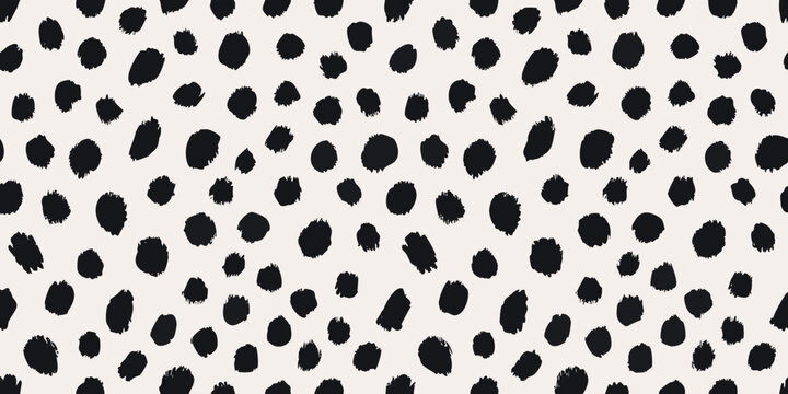 A seamless pattern of irregular black spots on a cream background