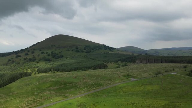 Aerial View of Green Cumbrian Fells with Mountain Backdrop in Lake District National Park England