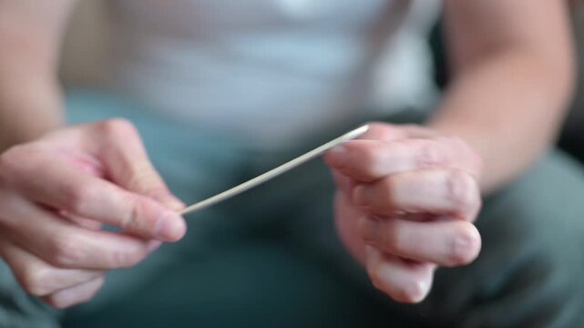 A person demonstrates the use of a nail file for grooming.