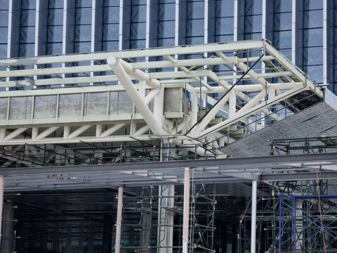 A large building with scaffolding on the roof. The scaffolding is being used to repair the roof