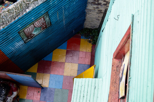 Colorful corrugated metal houses and painted window mural in Caminito, La Boca. 