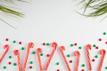 Christmas Candy Canes with Festive Sprinkles on White Background