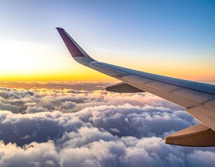 Obraz premium A wing of an airplane flying above clouds during sunrise