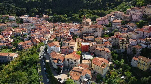 Scenic aerial view of Maratea with traditional terracotta rooftops and colorful buildings nestled in lush green hills in southern Italy.